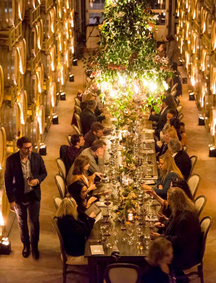 A table full of Kosta Browne members in discusssion before a special dinner.